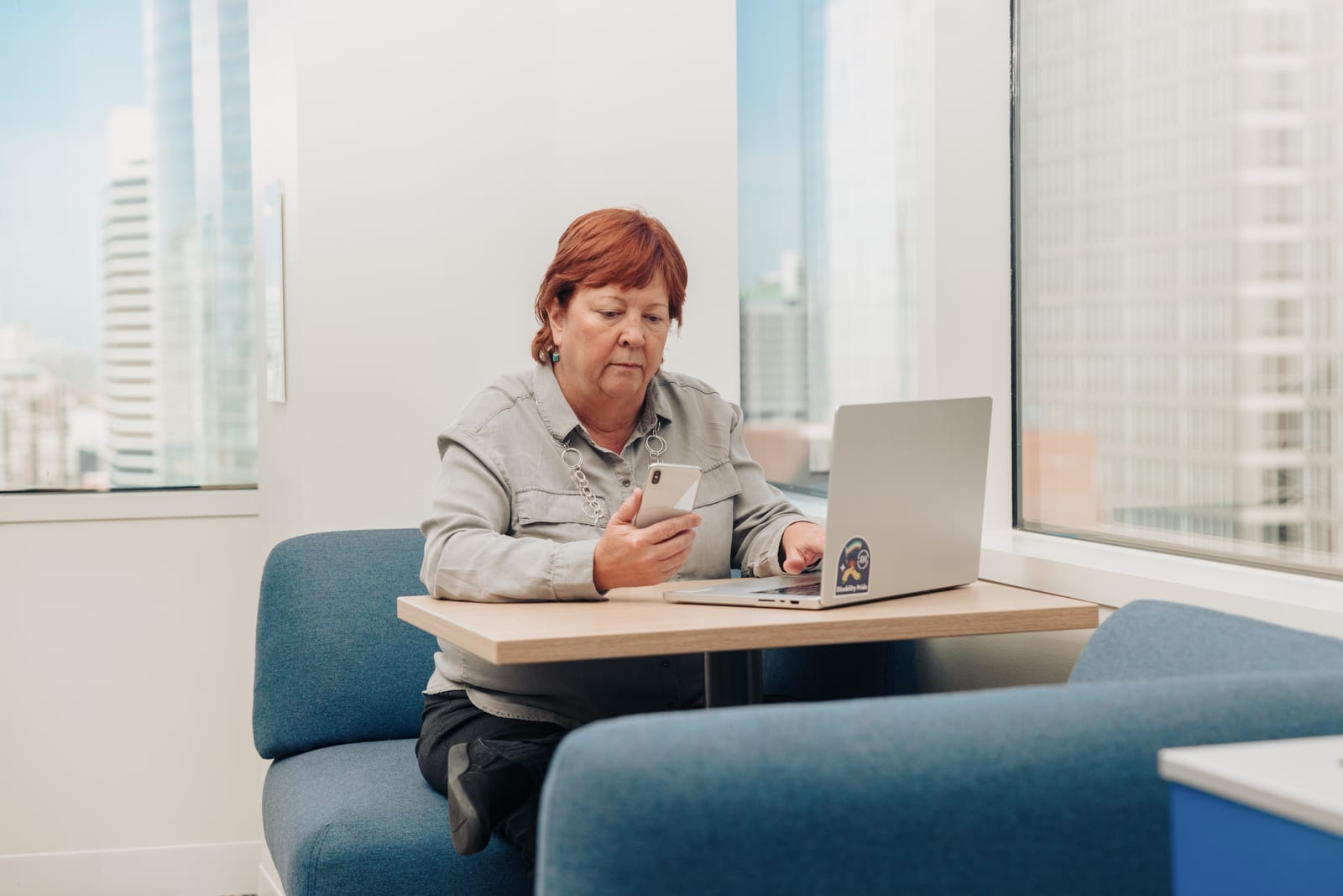 Professional working across multiple devices showcasing digital inclusion